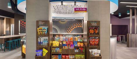 A snack kiosk with a sign indicating it's a 24/7 market.