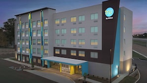 A modern hotel building with a prominent 'tru by Hilton' sign, multiple floors, and a covered entrance area. - Tru By Hilton Jackson, Tn (Jackson)