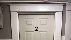 A closed door with the number 2 on it, set in a hallway with white trim and a wooden floor. - Cozy Loft Hideaway in Robinson (Robinson)