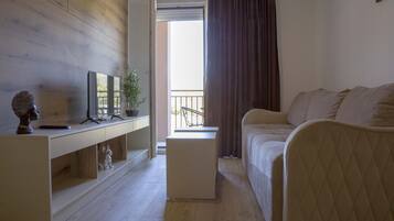 Elite Apartment | Living area | 32-inch flat-screen TV with cable channels