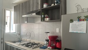 Coffee/tea maker, fridge, blender, cookware/dishes/utensils