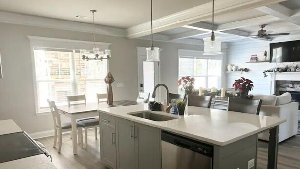 A modern kitchen with a central island, built-in appliances, and pendant lighting. - Spacious & Cozy Turnkey Master’s Tournament Rental with Concierge Level Service (Grovetown)