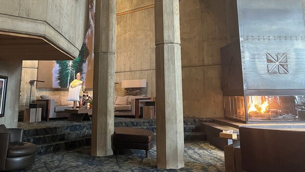 A spacious lobby with high ceilings, a central fireplace, and a seating area with a patterned carpet. - Amazing two story loft condo at Snowbird, UT: March 21-28, 2026: Timeshare. (Snowbird)