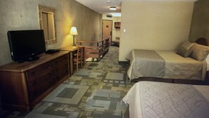 A hotel room with a television on a wooden dresser, a desk with a lamp, a bed, and a mirror on the wall. - Amazing two story loft condo at Snowbird, UT: March 21-28, 2026: Timeshare. (Snowbird)