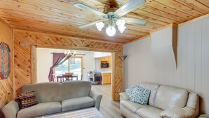 A wooden-floored living room with two sofas, a ceiling fan, and a table with a tissue box. - Lead Hideaway w/ Fireplace, Grill & New Deck! (Lead)
