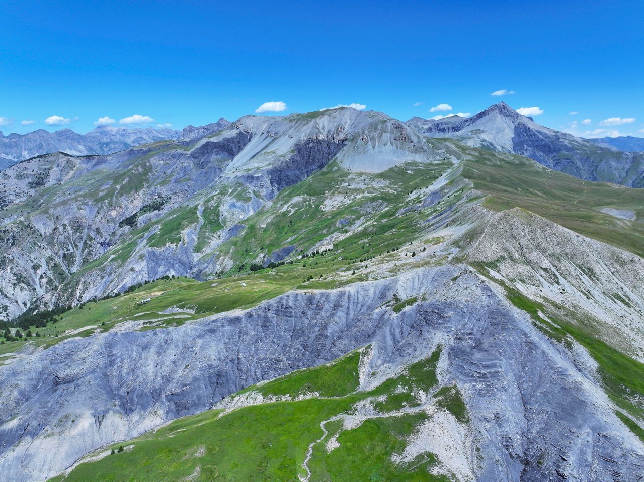 A mountainous landscape with rugged terrain and sparse vegetation.