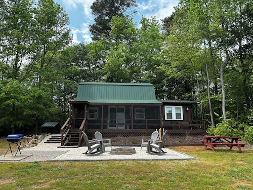 Cozy cabin on 16.5 acres with a stocked fishing pond. Close to Charlotte.  