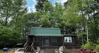 Cozy cabin on 16.5 acres with a stocked fishing pond. Close to Charlotte.