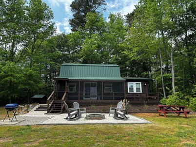 Cozy cabin on 16.5 acres with a stocked fishing pond. Close to Charlotte.  