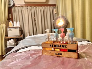 A wooden storage box labeled "STORAGE" with numbered compartments on a bed. - Koubounoyu Honten (Izunokuni)