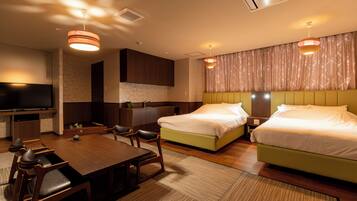 A hotel room with a bed, a desk, a chair, a television, and a bathroom.