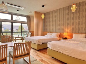 A hotel room with two beds, a dining area with chairs, and large windows offering a view. - Koubounoyu Honten (Izunokuni)