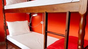 A bunk bed in a room with red walls and a tiled floor.