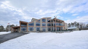 A modern multi-story building with a covered entrance and large windows. - Poconos Getaway / Lake, Pools, Fire Pit & Ski Big Bear / Sleeps 10 (Lackawaxen)