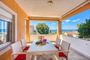A balcony with a table set for two, overlooking a scenic view. - Coastal Paradise Villa with Pool, Sveti Filip i Jakov, Croatia (Sveti Filip i Jakov)