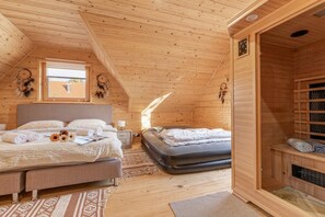A wooden cabin with a loft bedroom, a sauna, and a view of the outside. - Nativa Log Cabin with Sauna, Podčetrtek, Slovenia (Podčetrtek)