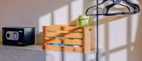 A wooden crate with a green towel and a black radio on a white surface.