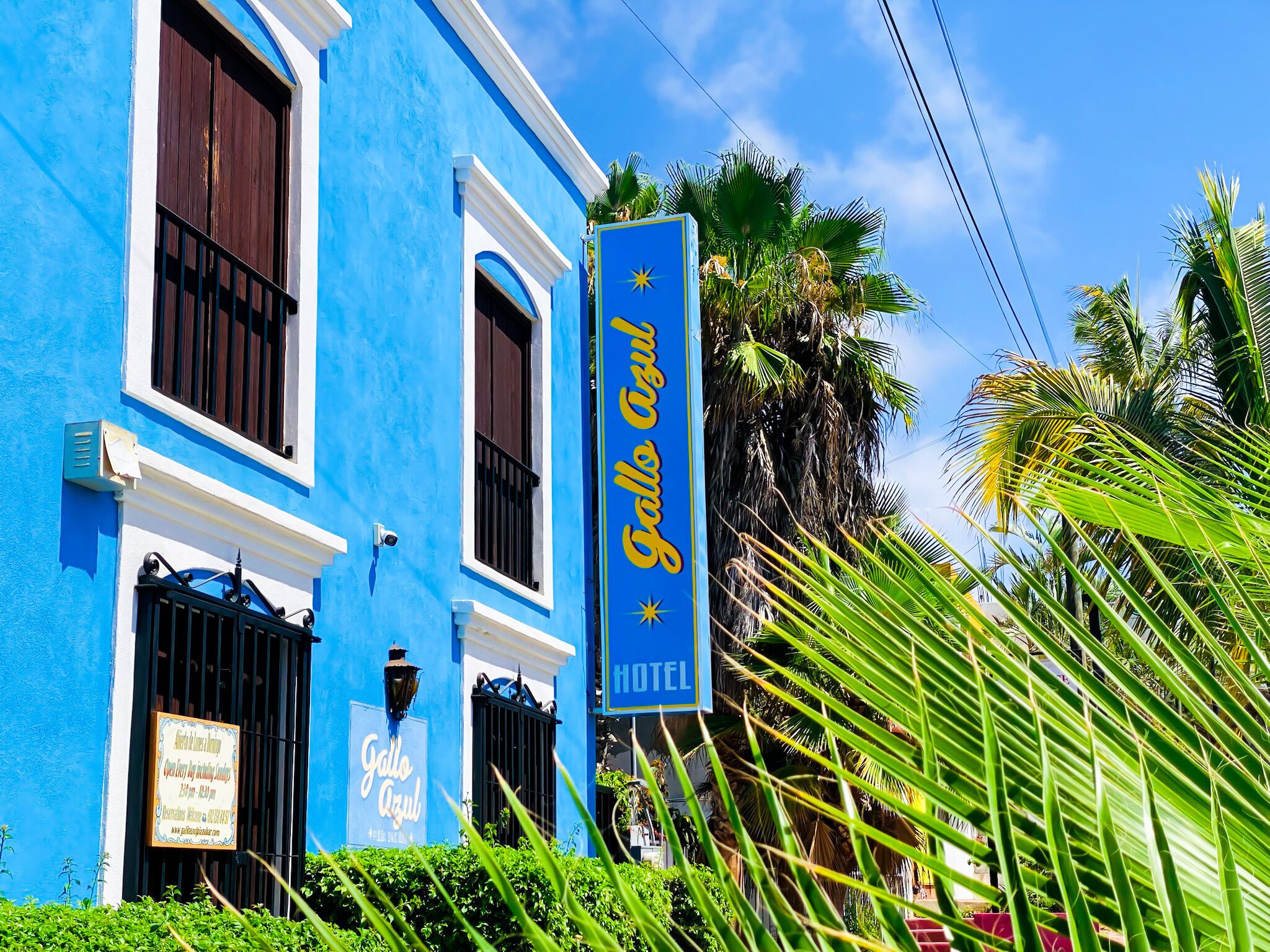 A blue building with a sign that reads "Gallo Azul Hotel".