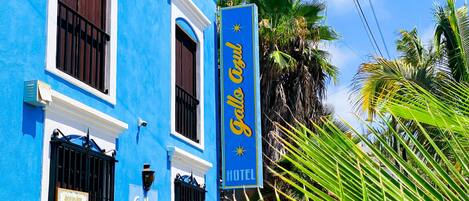 A blue building with a sign that reads "Gallo Azul Hotel".