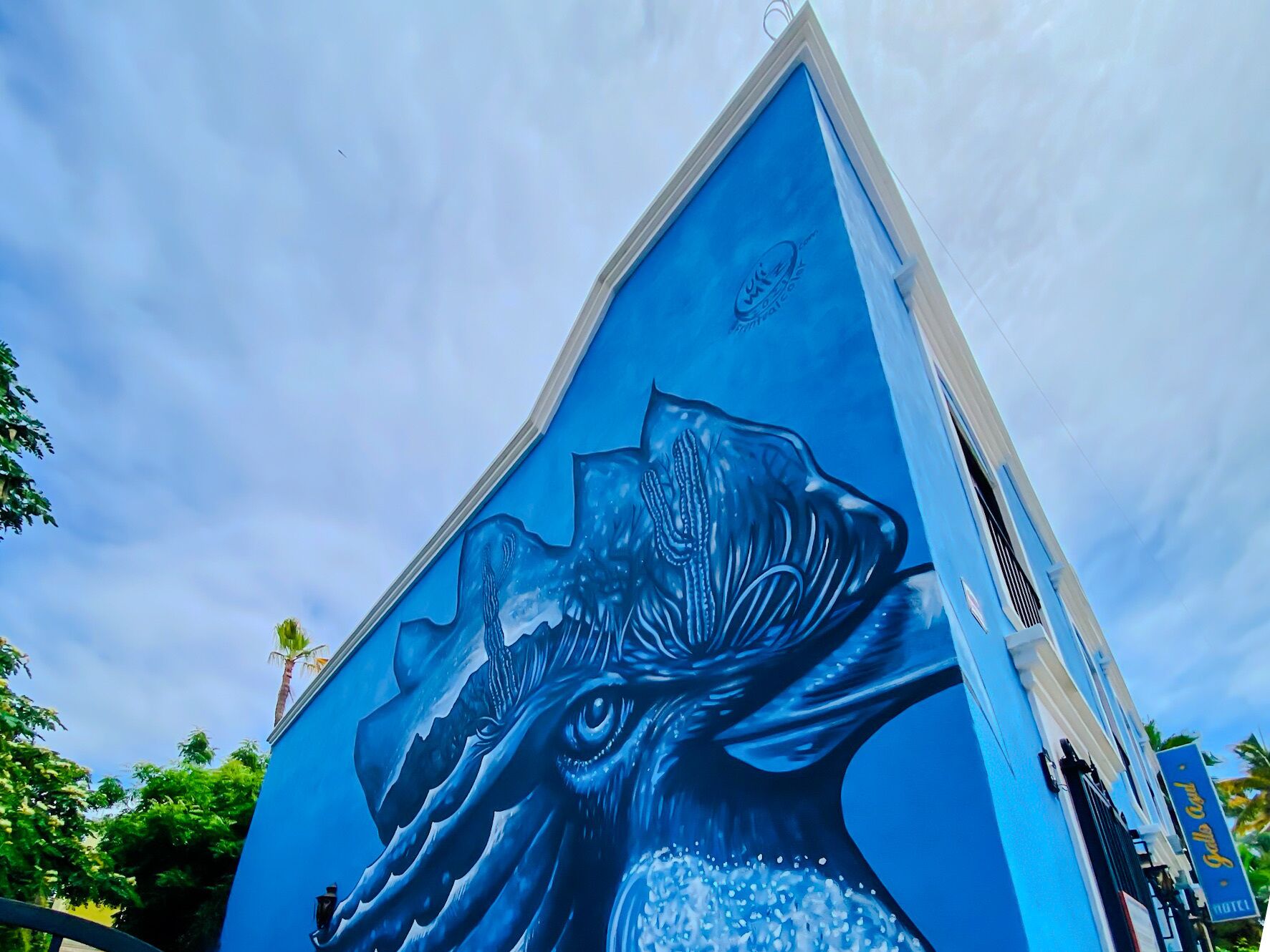 A building with a mural of a large bird, possibly a hawk, on its side.