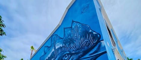 A building with a mural of a large bird, possibly a hawk, on its side.