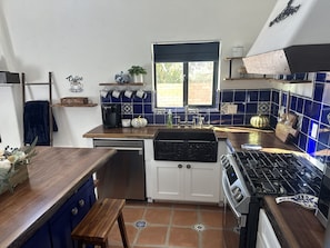 Enjoy cooking in this kitchen with a central island, dishwasher, and stainless steel stove.