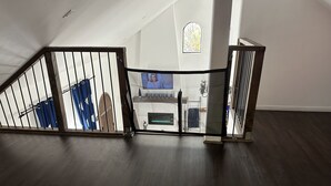 Una escalera con barandilla de madera que lleva a una plataforma.