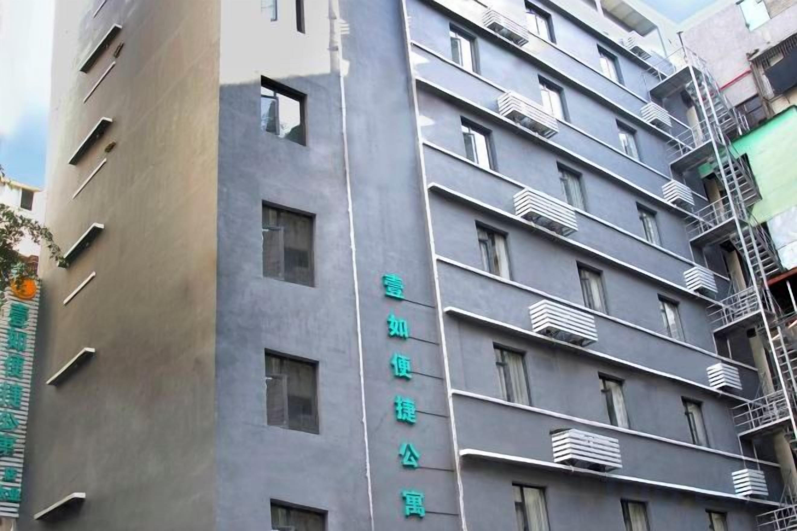 A multi-story building with balconies and windows.