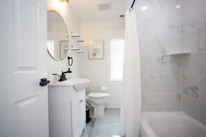 Hair dryer, towels, shampoo, toilet paper