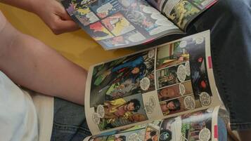 A person reading a comic book.