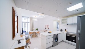 Deluxe Apartment | Living area | 55-inch Smart TV with cable channels - Magnificent Two Bedroom Beachfront (Dubai)