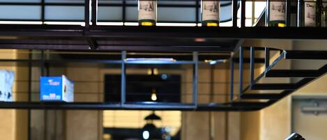 A bar area with a menu board, bottles of wine, and various drinks on the counter.