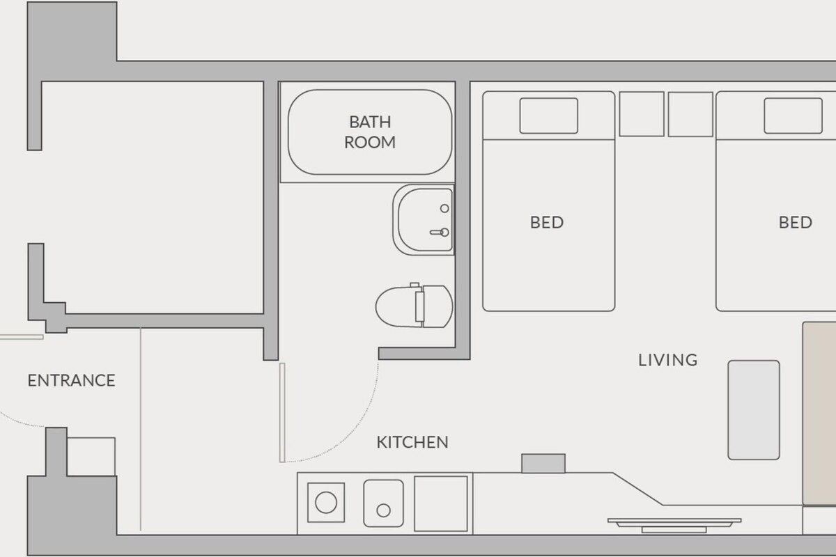 A floor plan with an entrance, kitchen, bathroom, two bedrooms, and a living area.