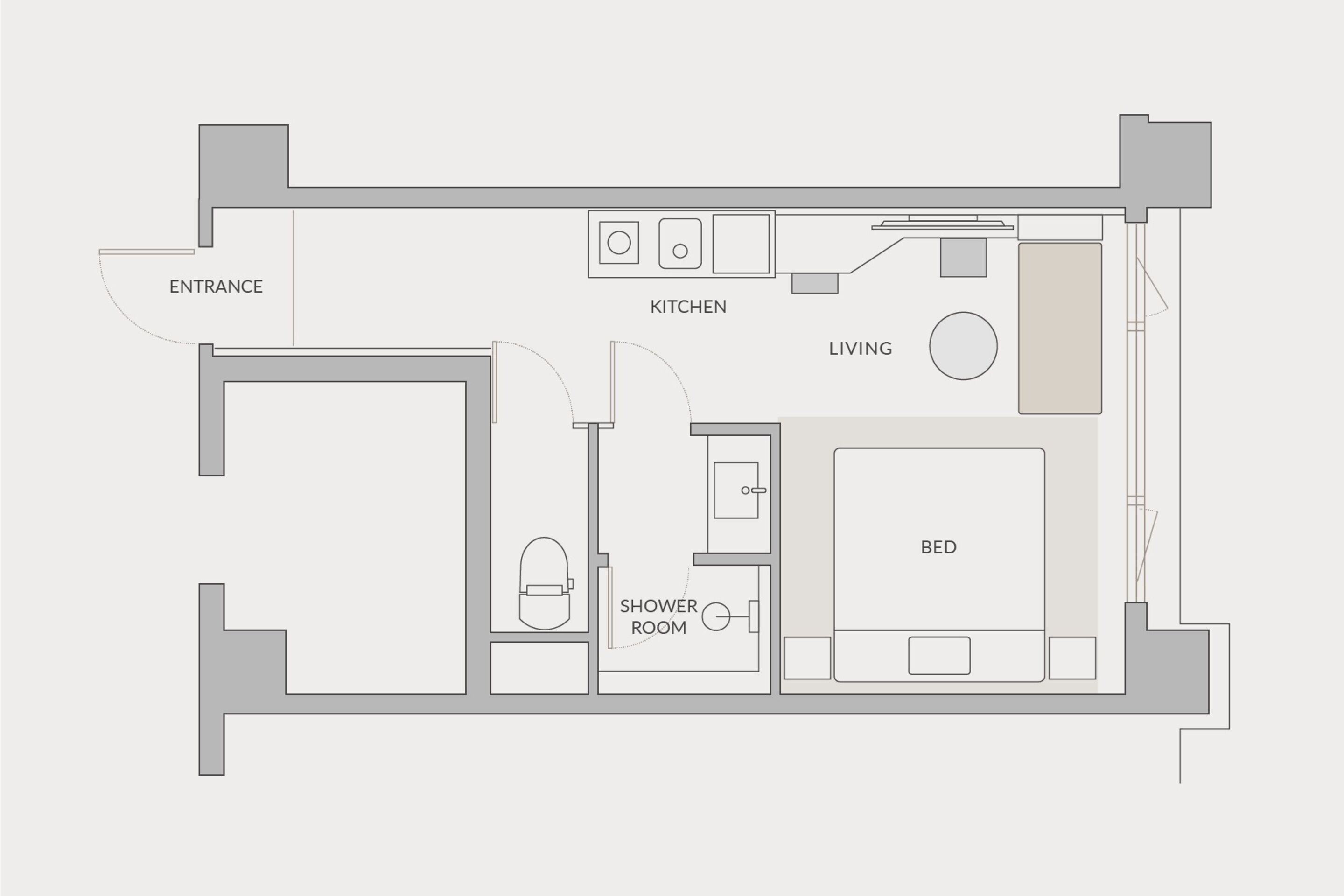 Un plan d’étage comprenant une entrée, une cuisine, un espace de vie et une chambre.