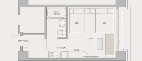 Un plano de planta que muestra una sala de estar, dos dormitorios, un baño y una cocina.