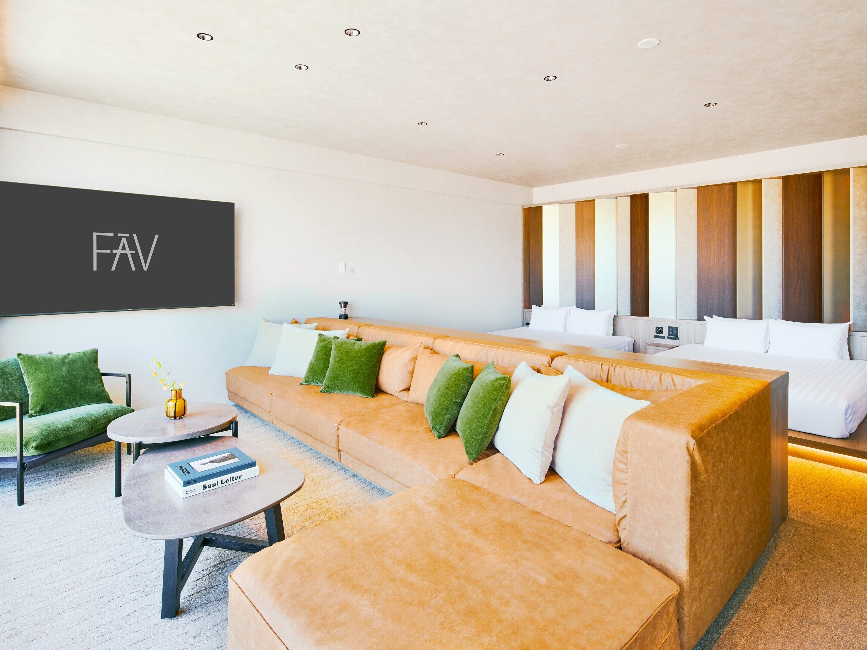 A modern hotel room with a sofa, a small table, and a bed.