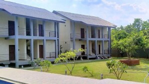 A two-story building with balconies and a swimming pool in the foreground. - Sigiriya Retreats (Sigiriya)