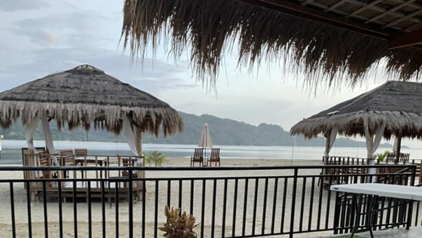 A pool area with a view of the beach and mountains. - Crystal Cove (Sipalay)