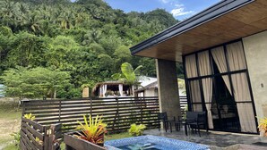 A modern building with large windows and a pool area. - Crystal Cove (Sipalay)