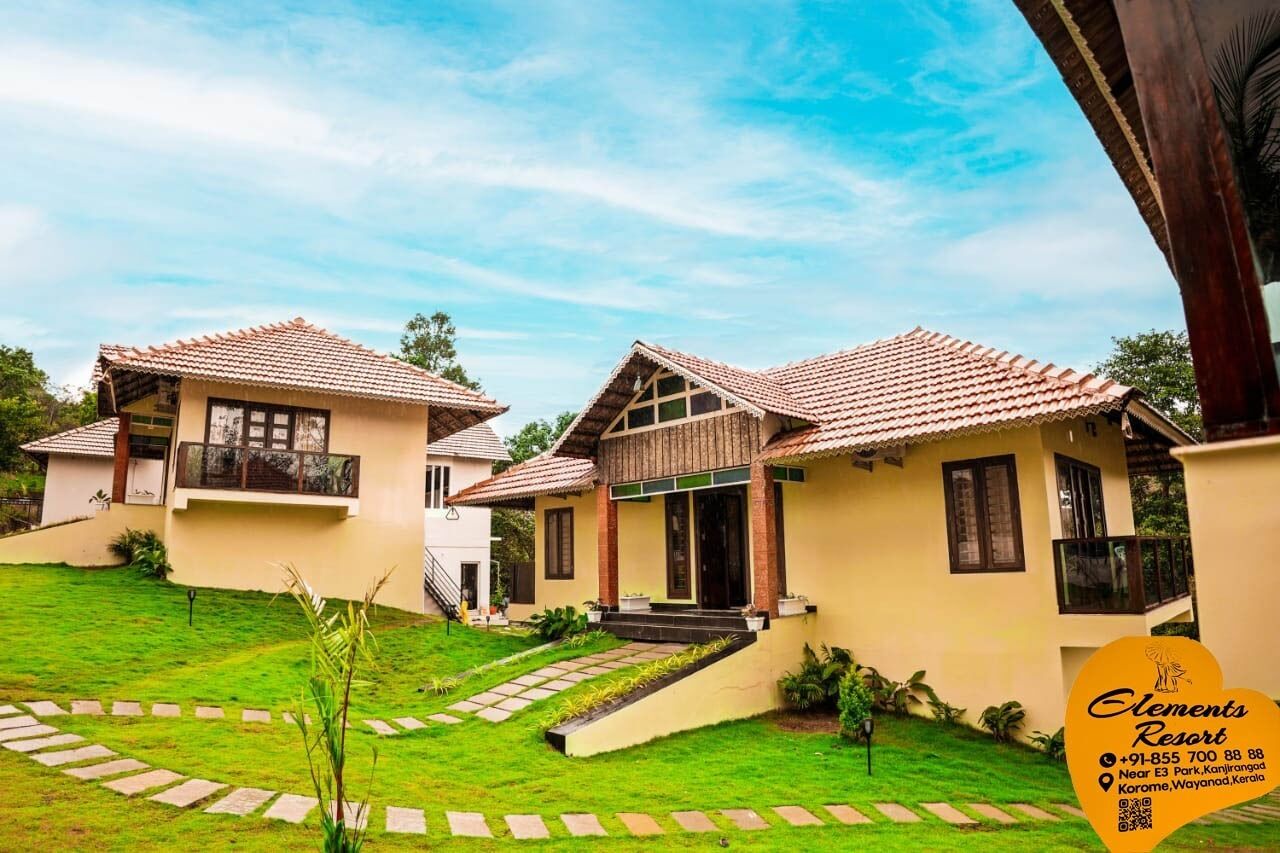 A resort with multiple buildings, a well-maintained lawn, and a contact number.