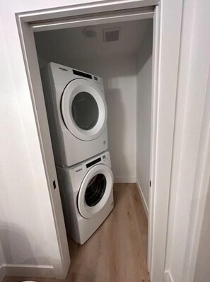 Convenient laundry facilities with two front-loading washing machines.
