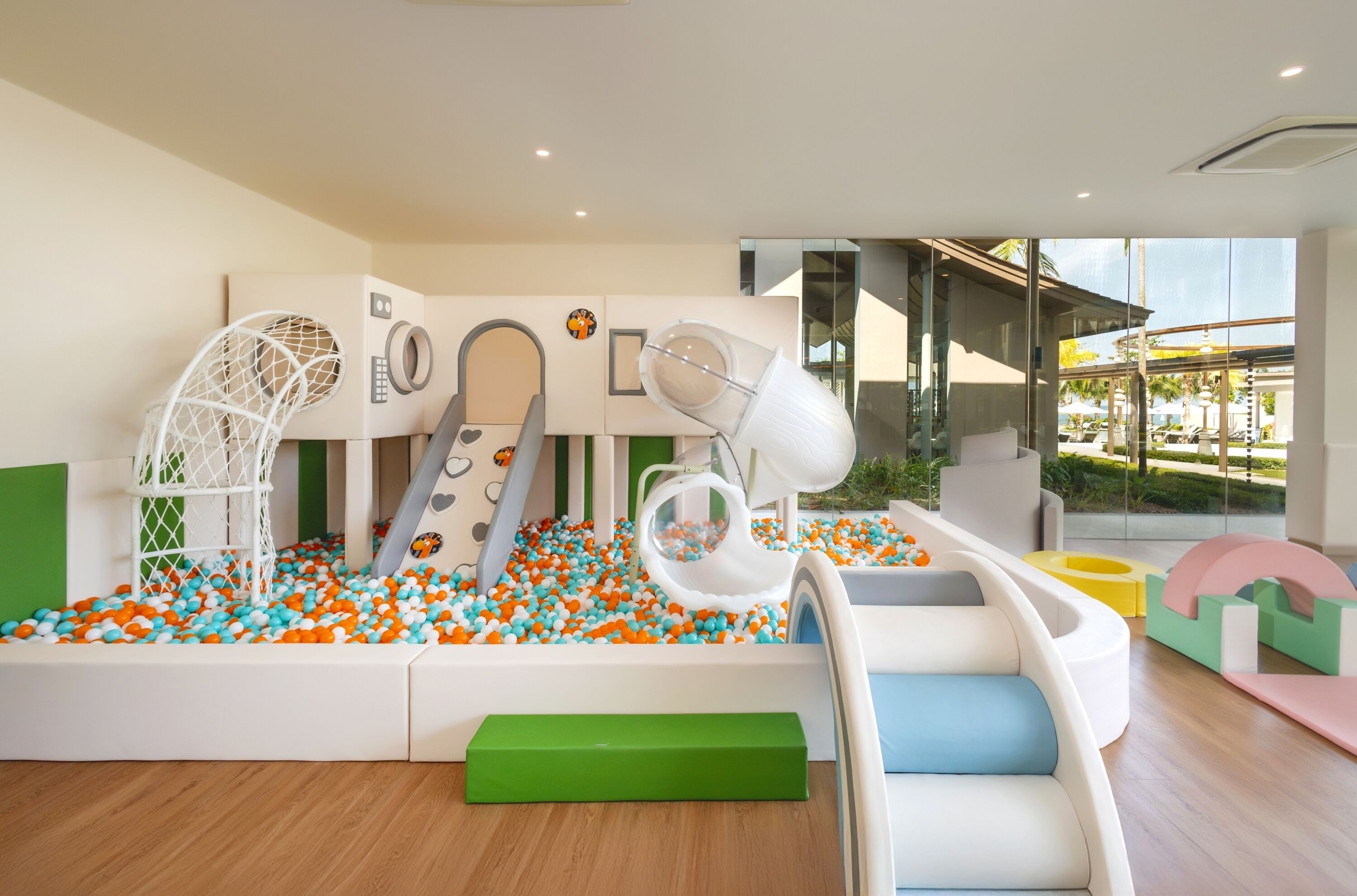 A children's play area with a ball pit, slides, and climbing structures.