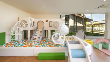 A children's play area with a ball pit, slides, and climbing structures.