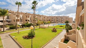 A hotel with multiple-story buildings, a swimming pool, and well-maintained lawns. - Vacation Apartment 'La Casita De La Tejita' with Shared Pool and Wi-Fi (Granadilla)