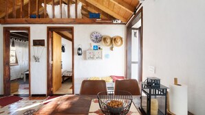 A dining area with a wooden table, chairs, a decorative bowl, and a lantern. - Holiday Home 'Media Pipa' with Sea View, Wi-Fi and Air Conditioning (Puntagorda)