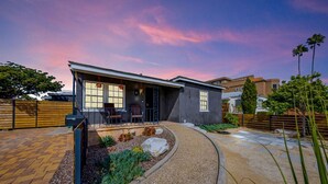 A modern house with a covered patio, a stone pathway, and a landscaped garden. - The Succulent House, parking, walk to Bay! (San Diego)