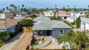 A residential house with a paved driveway, a small patio area, and a well-maintained garden. - The Succulent House, parking, walk to Bay! (San Diego)