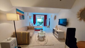 A modern living room with a sofa, a coffee table, a TV, and a water dispenser. - Diani Beach (Kwale)