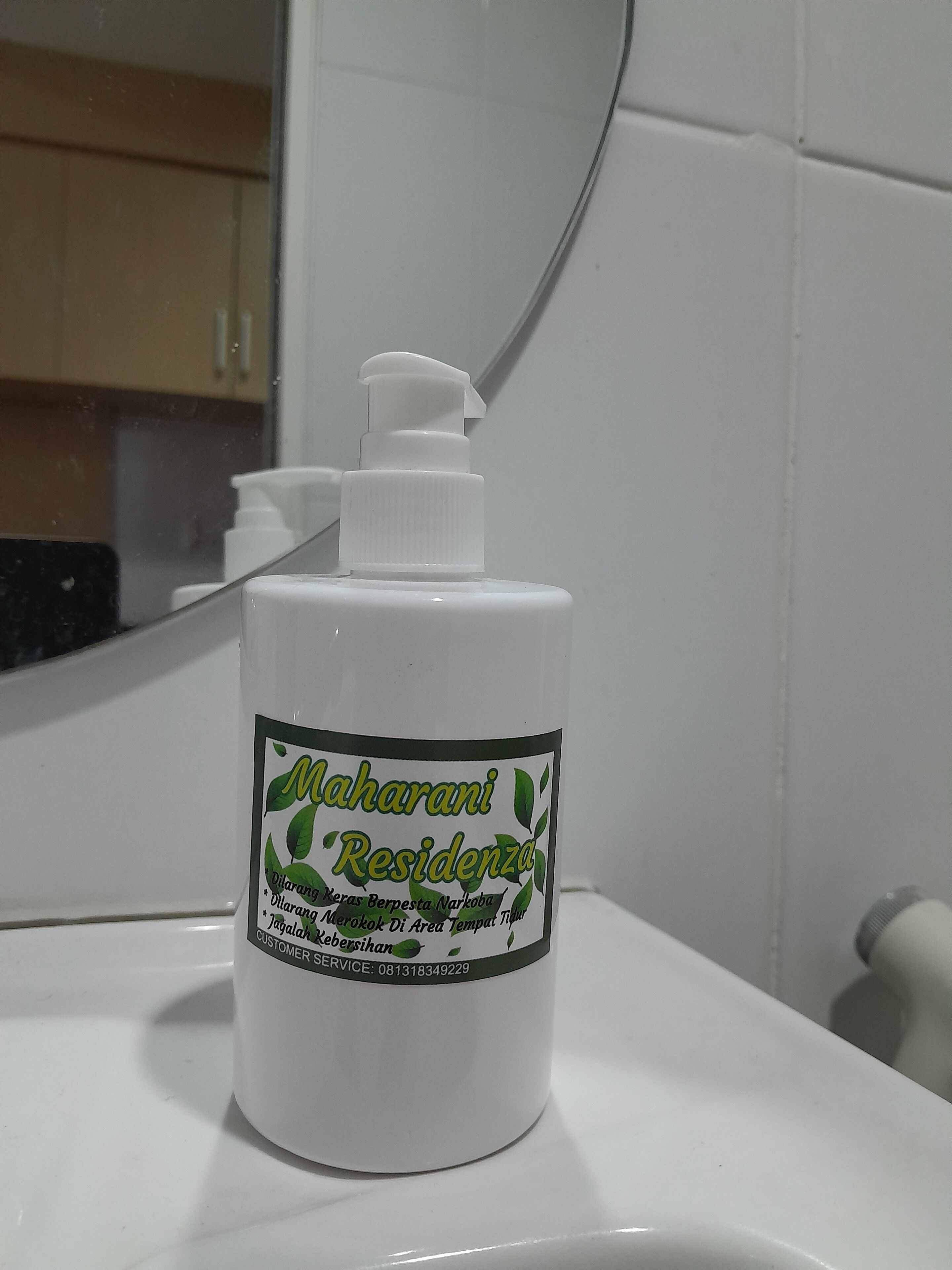 A bottle of 'Maharani Residencia' hand soap on a bathroom sink.