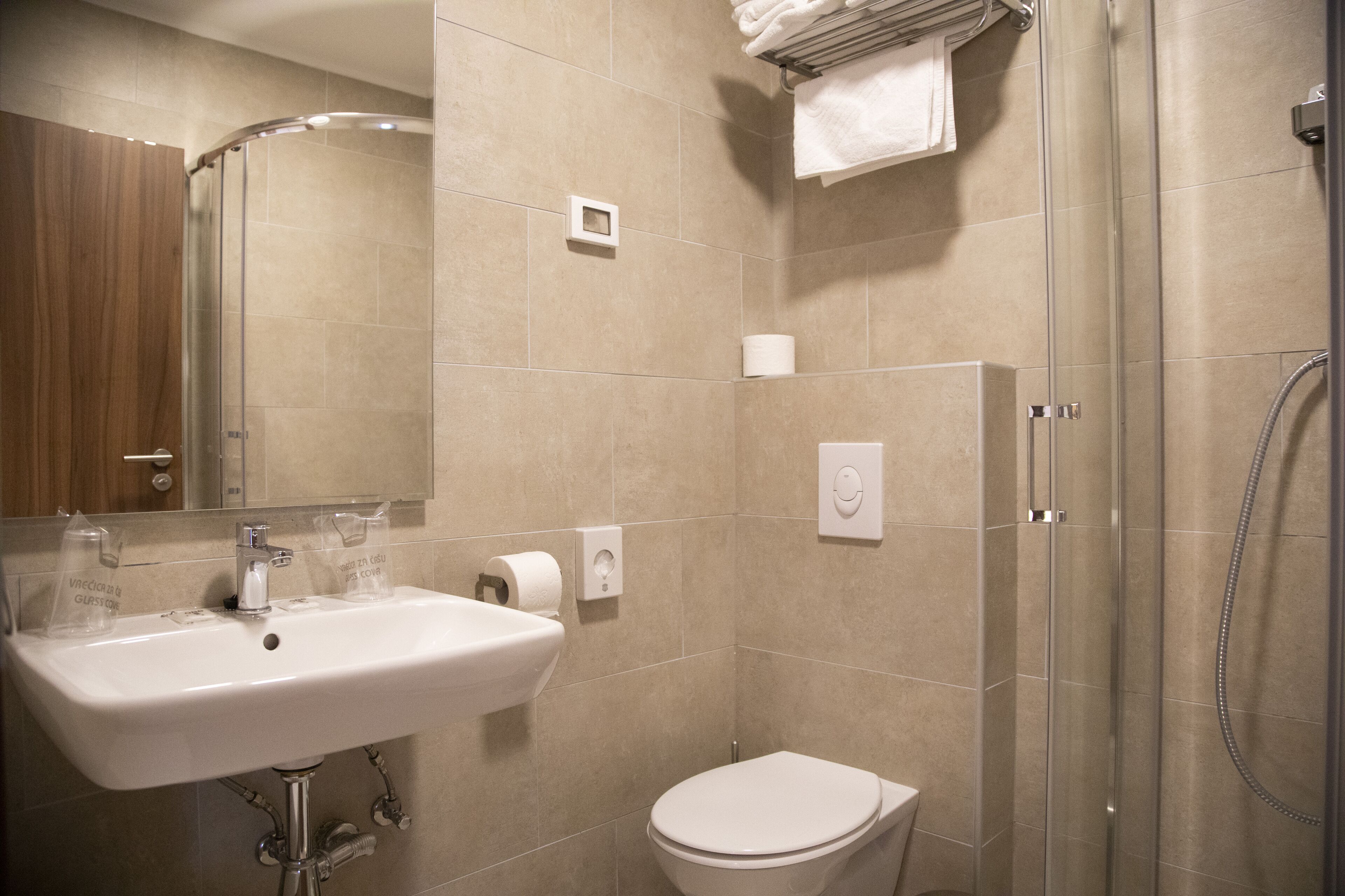 A bathroom with a sink, toilet, and shower.